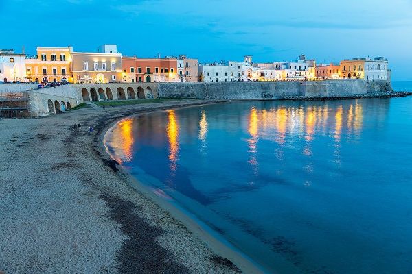 Italy-Apulia-Province of Lecce-Gallipoli Beach and old town section over the Ionian Sea at dusk